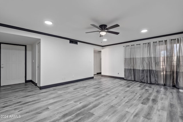 spare room with light hardwood / wood-style flooring, ornamental molding, and ceiling fan