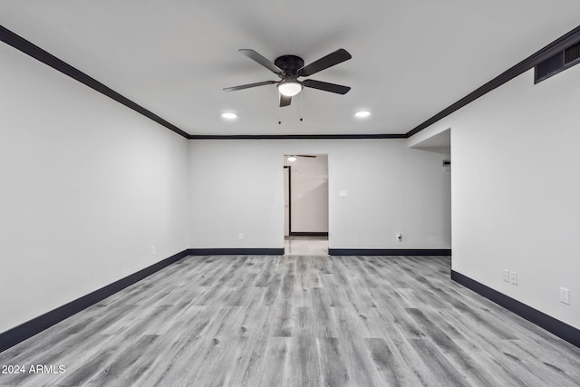 spare room featuring light hardwood / wood-style floors, ornamental molding, and ceiling fan