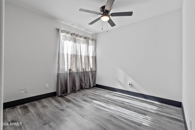 empty room featuring ceiling fan and light hardwood / wood-style flooring