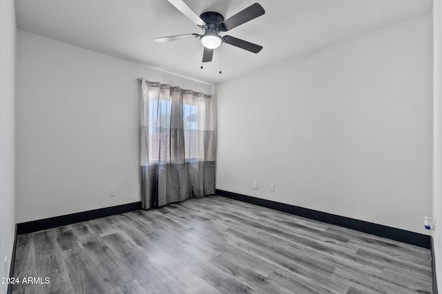 spare room featuring light hardwood / wood-style floors and ceiling fan