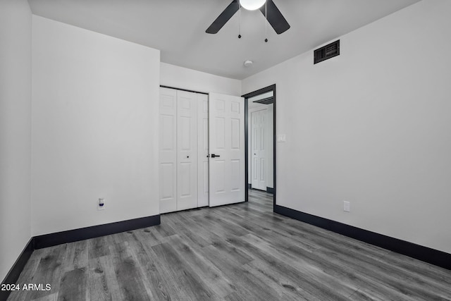 unfurnished bedroom with a closet, light wood-type flooring, and ceiling fan