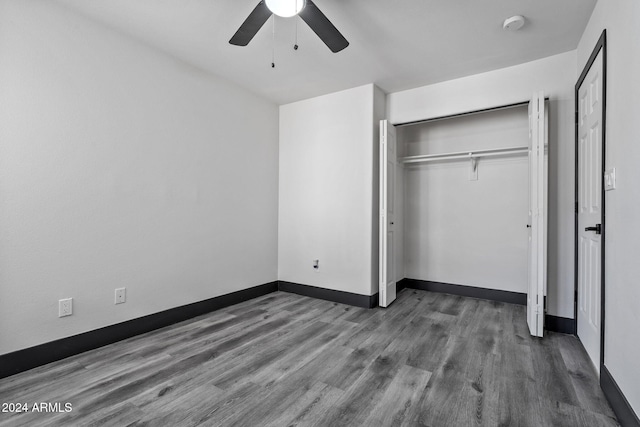 unfurnished bedroom with a closet, ceiling fan, and wood-type flooring