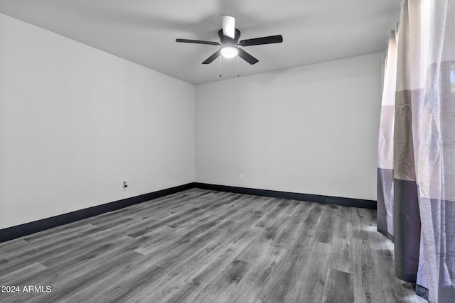 spare room with hardwood / wood-style flooring and ceiling fan