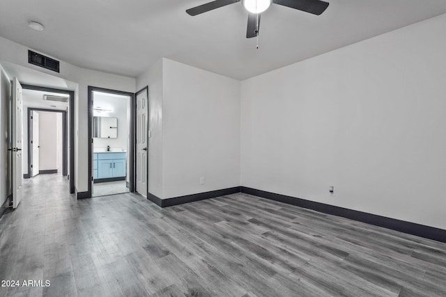 empty room with ceiling fan and hardwood / wood-style floors