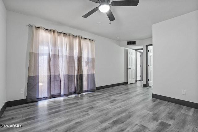 unfurnished room with wood-type flooring and ceiling fan