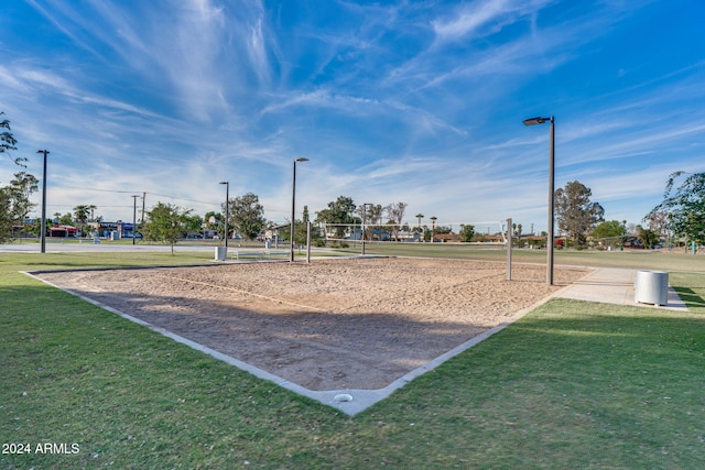 view of property's community featuring a yard and volleyball court