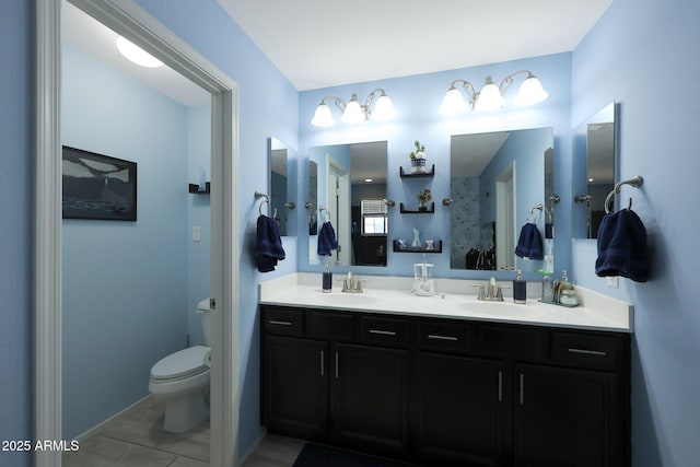 bathroom with toilet, tile patterned flooring, and vanity