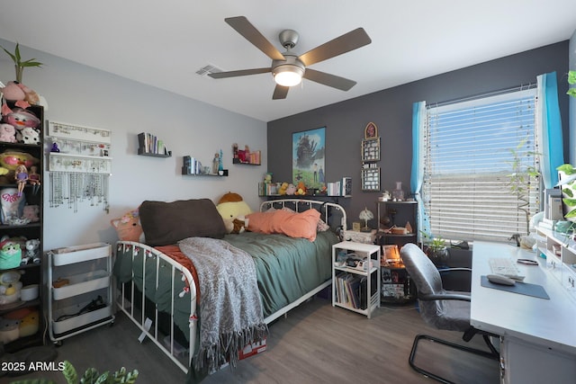 bedroom with ceiling fan and dark hardwood / wood-style flooring