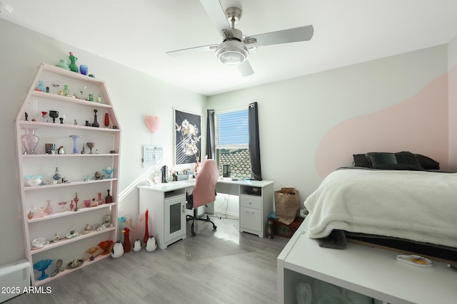 bedroom with ceiling fan and light hardwood / wood-style floors