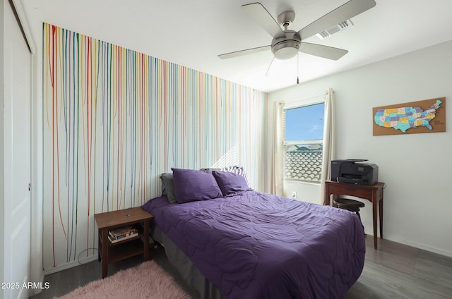 bedroom with ceiling fan and wood-type flooring