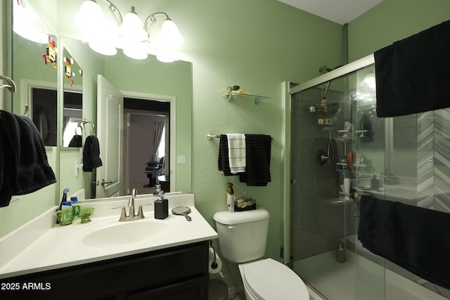 bathroom with toilet, vanity, a shower with door, and an inviting chandelier