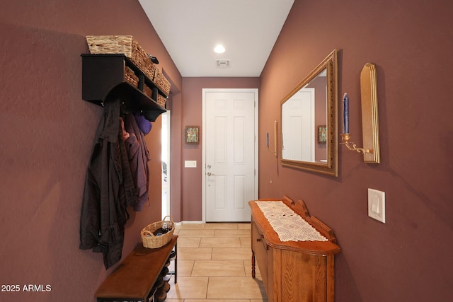 doorway to outside featuring light tile patterned flooring