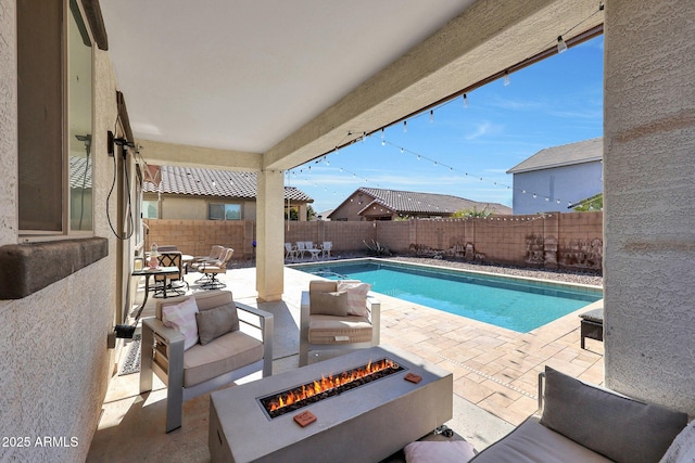 view of swimming pool featuring a patio area and an outdoor fire pit