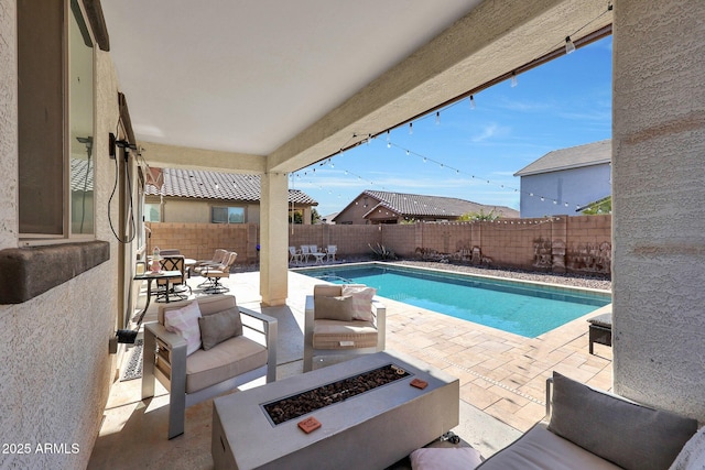 view of swimming pool with a fire pit and a patio