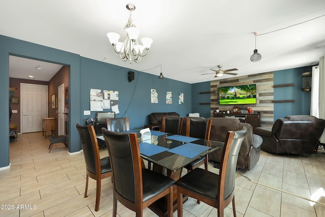 dining area with ceiling fan with notable chandelier and light hardwood / wood-style flooring