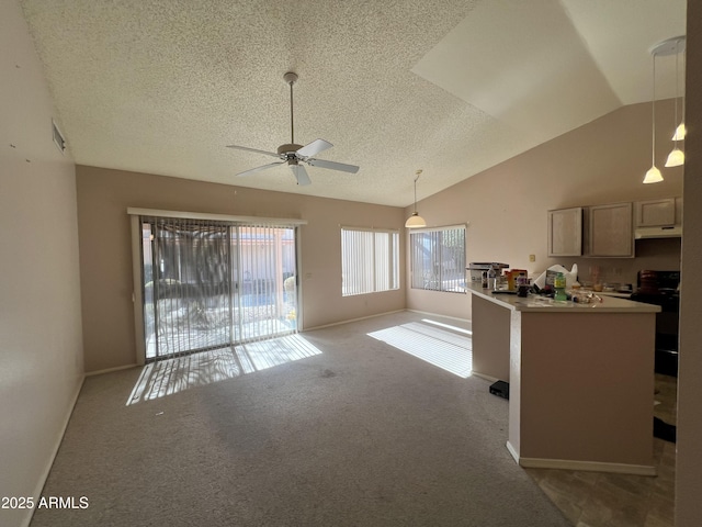 kitchen with ceiling fan, pendant lighting, a textured ceiling, vaulted ceiling, and light carpet