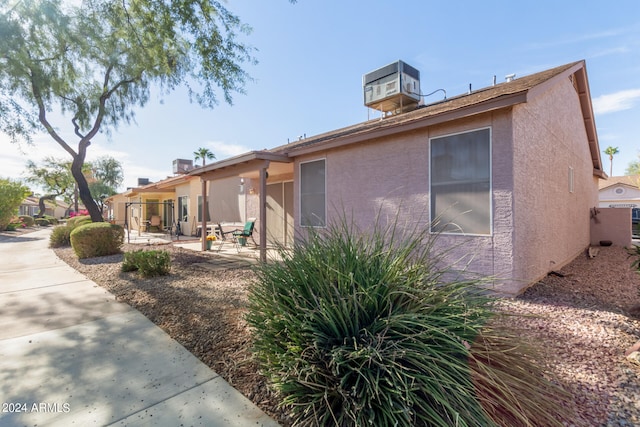 back of house featuring central AC and a patio area