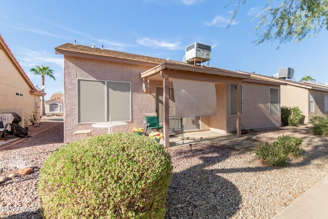 rear view of house with a patio area and cooling unit