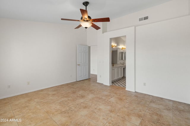 unfurnished bedroom with ceiling fan and ensuite bathroom