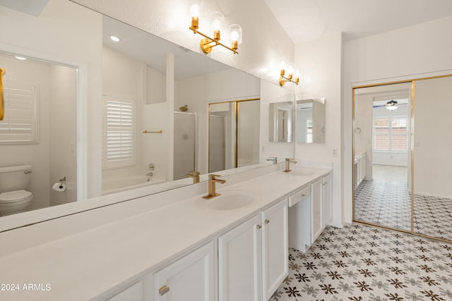 full bathroom featuring ceiling fan with notable chandelier, lofted ceiling, separate shower and tub, vanity, and toilet