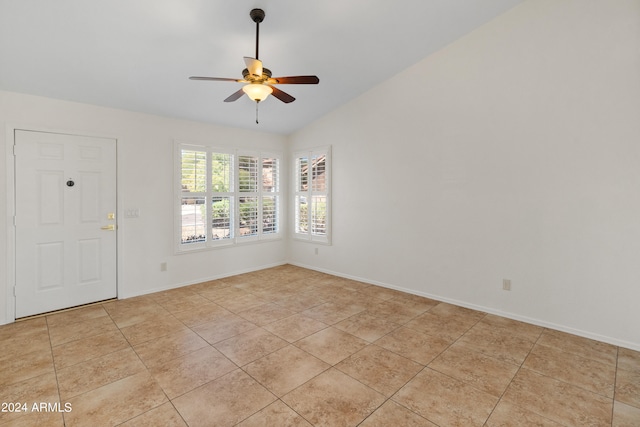 tiled empty room with ceiling fan and lofted ceiling