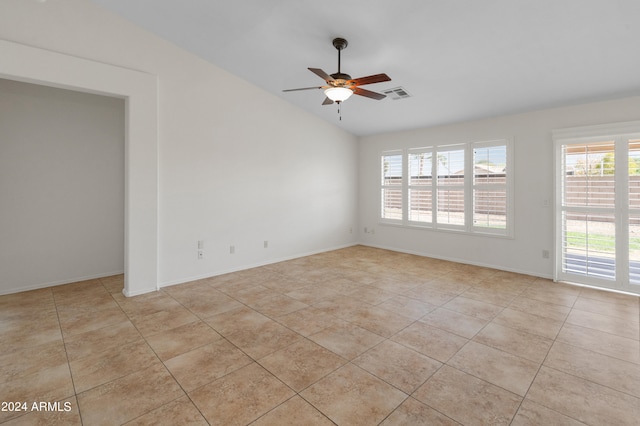 tiled empty room featuring lofted ceiling and ceiling fan