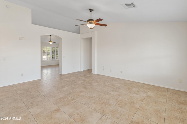 empty room with light tile patterned floors, lofted ceiling, and ceiling fan