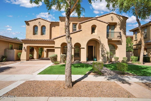 4120 E Woodside Way, Gilbert, AZ 85297 - mediterranean / spanish-style home featuring a balcony, decorative driveway, stucco siding, and a front yard