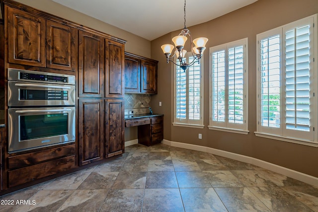 4120 E Woodside Way, Gilbert, AZ 85297 - kitchen featuring double oven, a chandelier, dark brown cabinets, hanging light fixtures, and decorative backsplash