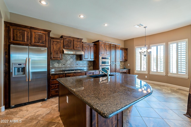 4120 E Woodside Way, Gilbert, AZ 85297 - kitchen with stainless steel appliances, under cabinet range hood, a chandelier, backsplash, and dark brown cabinetry