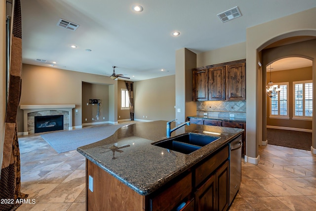 4120 E Woodside Way, Gilbert, AZ 85297 - kitchen with ceiling fan, a kitchen island with sink, dark stone counters, backsplash, and recessed lighting