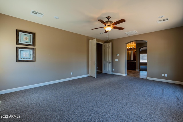 4120 E Woodside Way, Gilbert, AZ 85297 - unfurnished bedroom featuring arched walkways, carpet flooring, and a ceiling fan