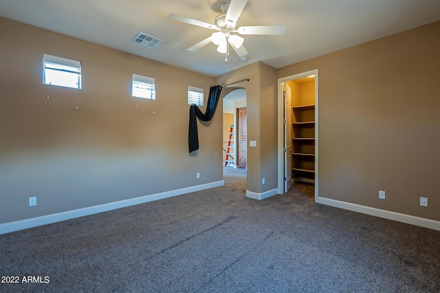 4120 E Woodside Way, Gilbert, AZ 85297 - spare room with dark carpet, arched walkways, and a ceiling fan