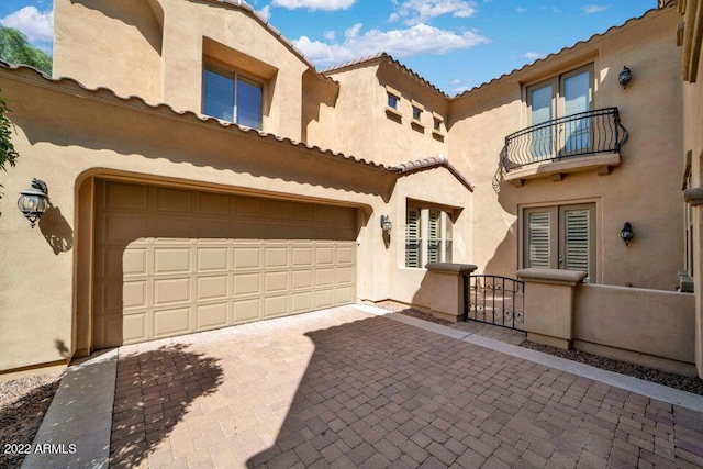 4120 E Woodside Way, Gilbert, AZ 85297 - view of front facade featuring a balcony, stucco siding, decorative driveway, and a garage