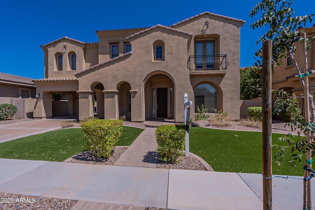 4120 E Woodside Way, Gilbert, AZ 85297 - mediterranean / spanish house featuring a balcony, stucco siding, a tiled roof, and driveway