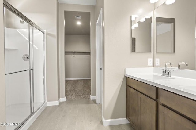 1471 S 239th Dr, Buckeye, AZ 85326 - full bath with a stall shower, vanity, baseboards, and a walk in closet