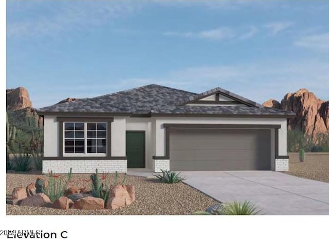 view of front facade with a garage, concrete driveway, brick siding, and stucco siding