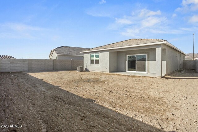 1471 S 239th Dr, Buckeye, AZ 85326 - rear view of house featuring cooling unit, a fenced backyard, stucco siding, a patio area, and a tiled roof