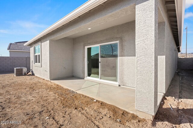 rear view of house featuring fence, a patio, and stucco siding