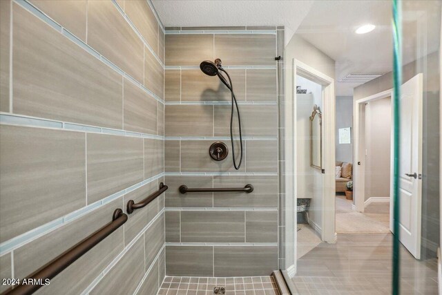 bathroom featuring walk in shower and tile patterned flooring