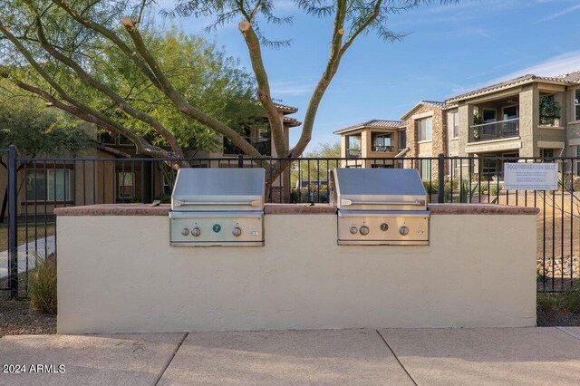 exterior space with area for grilling, a balcony, and a grill