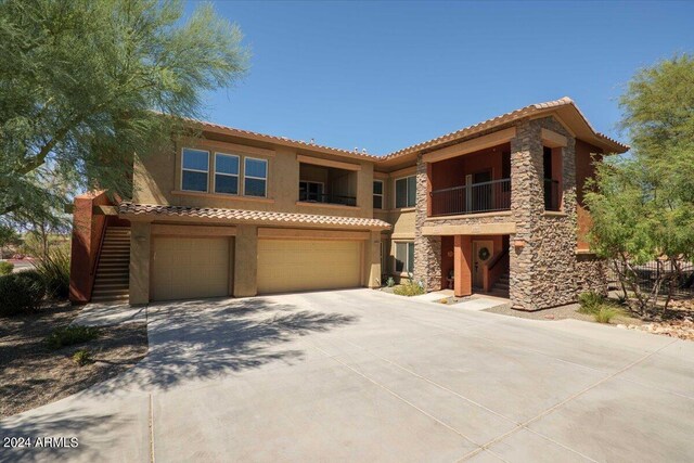 mediterranean / spanish-style home with a balcony and a garage