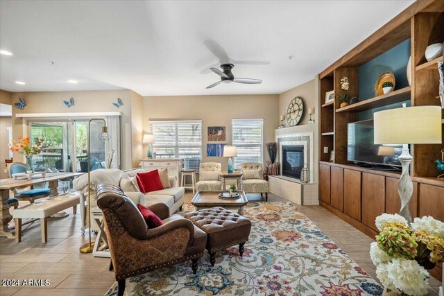 living room with light hardwood / wood-style floors and ceiling fan