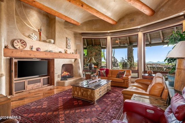 41731 N Stone Cutter Dr, Scottsdale, AZ 85262 - living room featuring beamed ceiling, a premium fireplace, and hardwood / wood-style floors