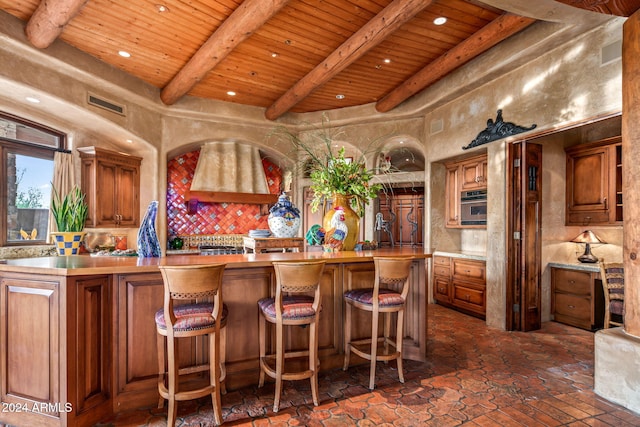 bar featuring beamed ceiling, stainless steel oven, wooden ceiling, and backsplash