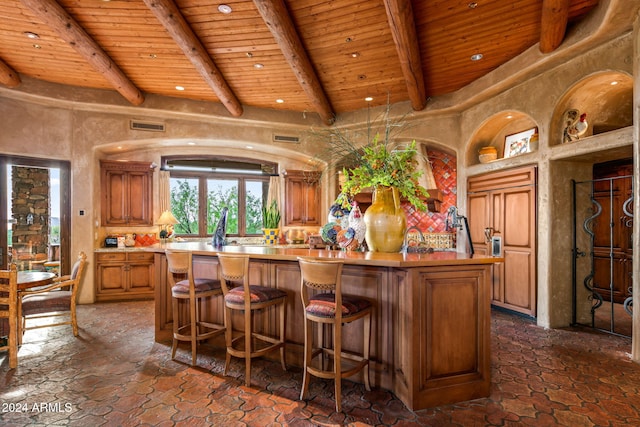 kitchen featuring beamed ceiling, a center island, and wooden ceiling