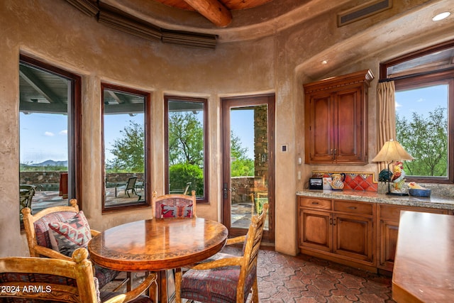 dining room featuring beamed ceiling