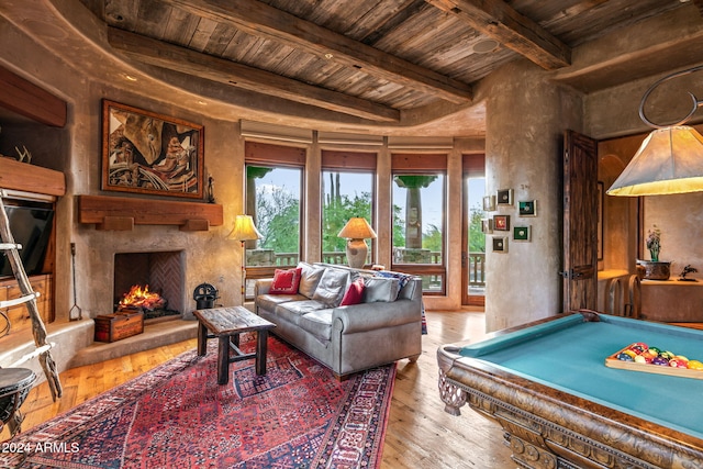 rec room featuring beamed ceiling, a fireplace, hardwood / wood-style floors, and wooden ceiling