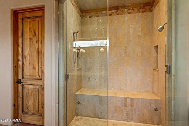 bathroom featuring a shower with shower door