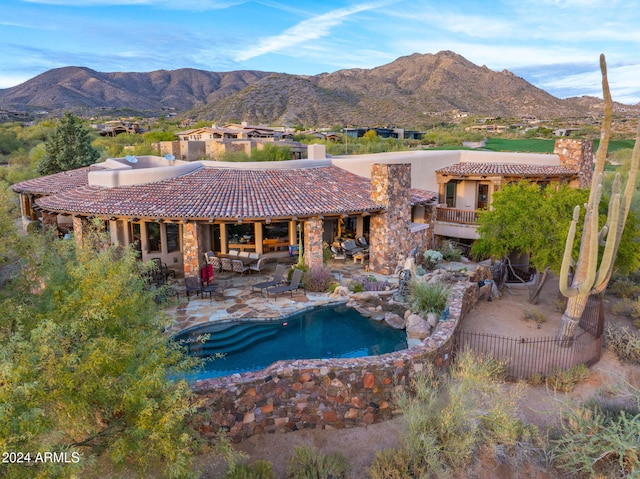 view of pool with a mountain view and a patio area